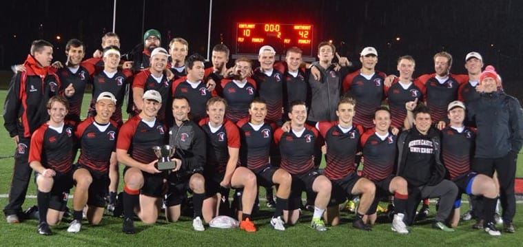 The 2017 Maddogs with the bowl trophy in front of the scoreboard