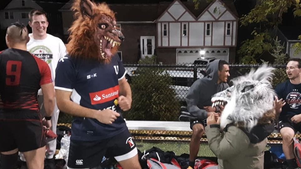 Maddog supporters in wolfman masks on the sideline
