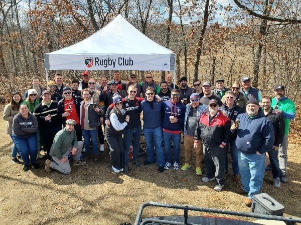 Alumni at the NU Rugby Club tailgate tent in Quincy