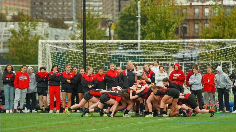The Northeastern women's team in a scrum at Carter Field